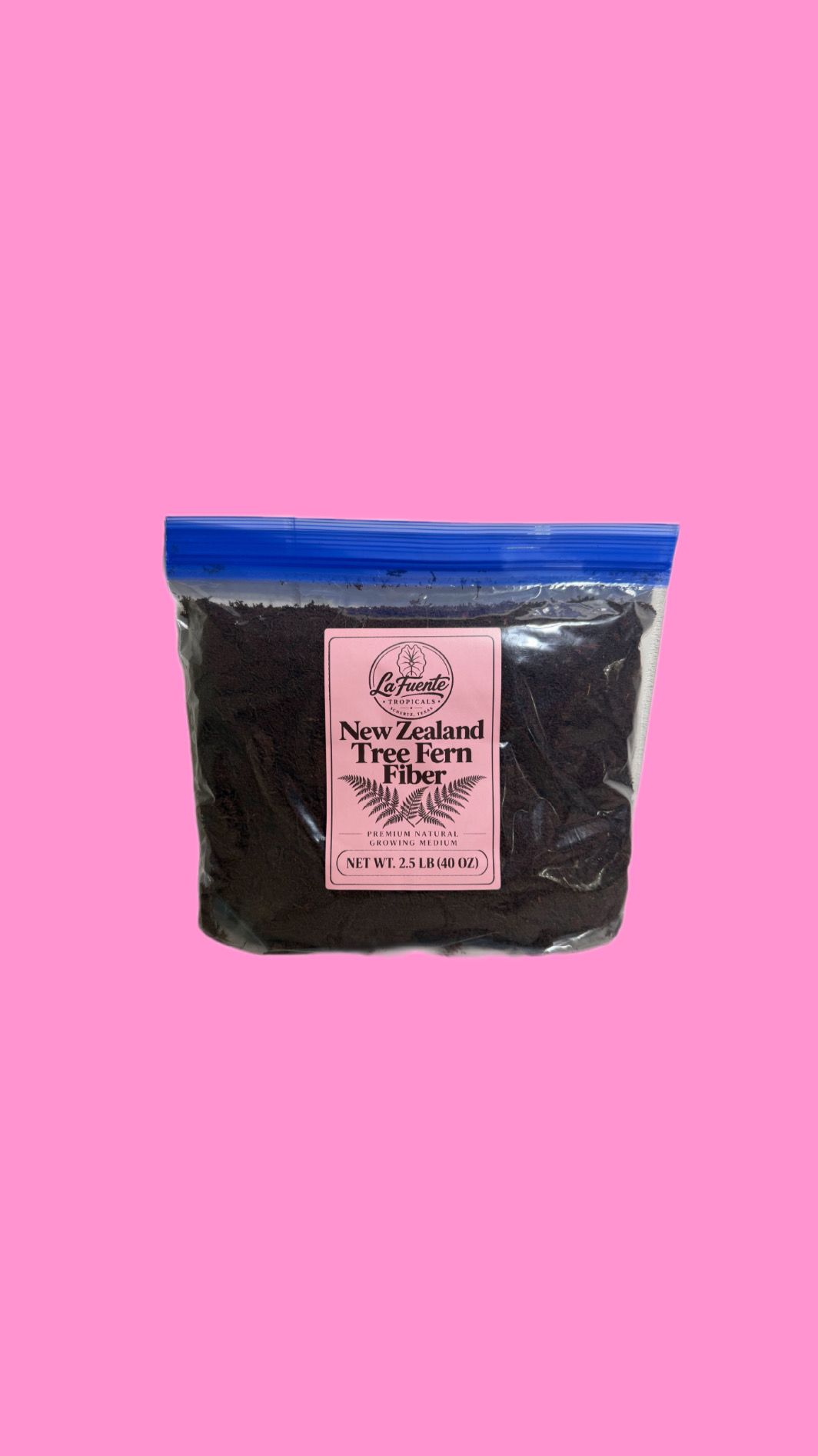 One gallon bag of New Zealand tree fern fiber on a pink background